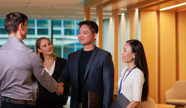 Two men in business attire shaking hands