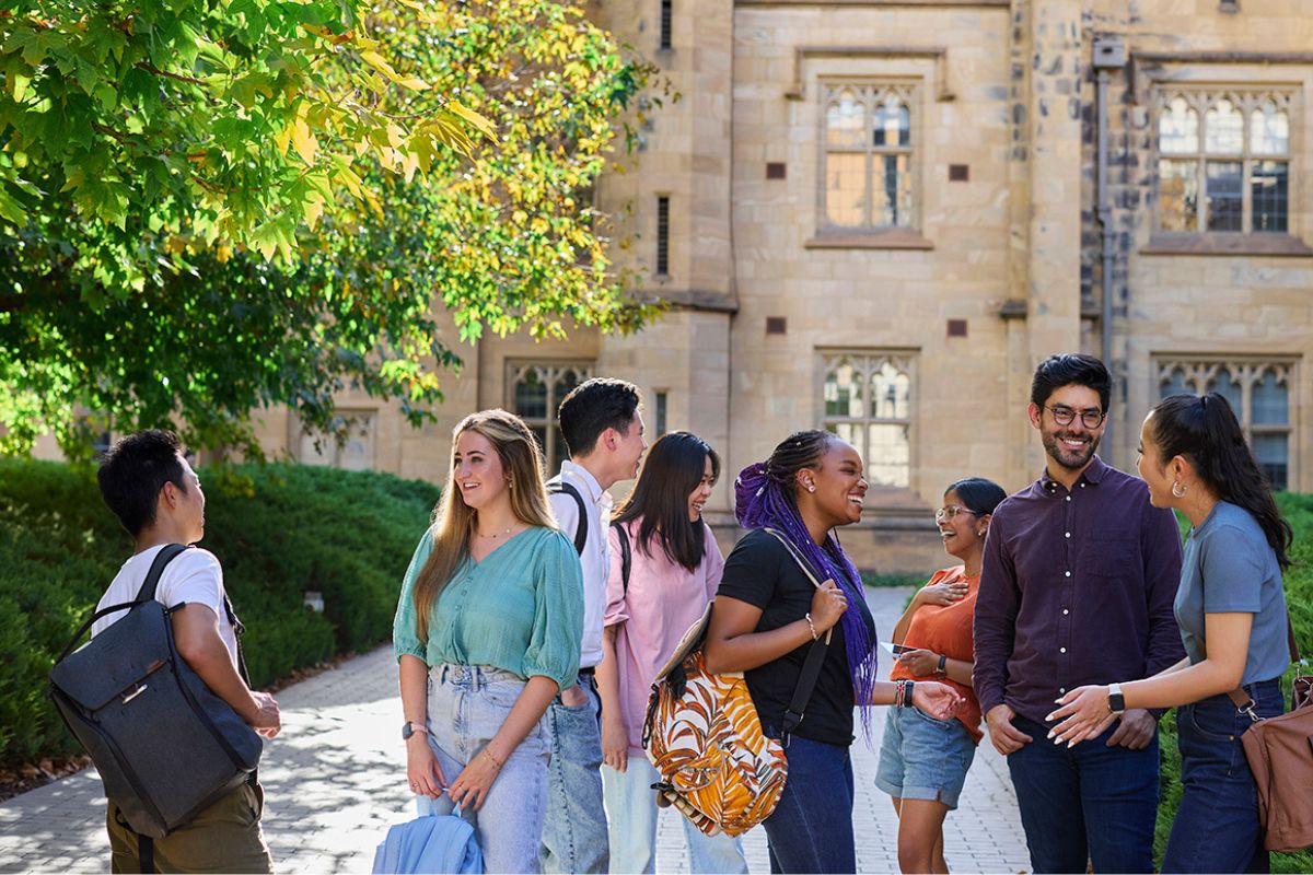 Students gathered in front of heritage buildings at Melbourne University