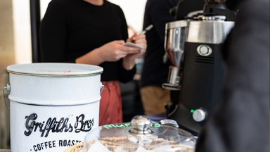 Cafe worker and coffee machine, tin with Griffiths Bros Coffee Roasters branding