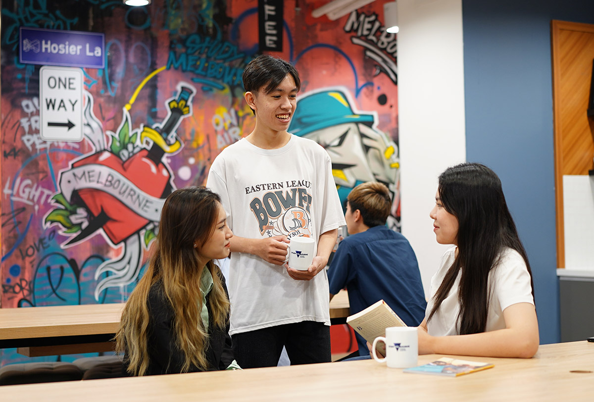 Students chatting in hub with graffiti