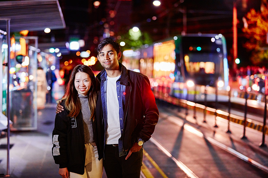 Couple standing on tram stop