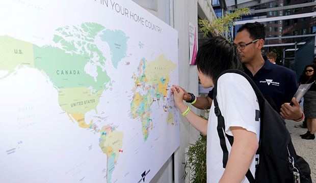 Student pinning location on World map