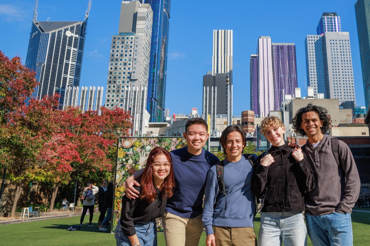 Students enjoying a day out in the city, tall buildings in the background