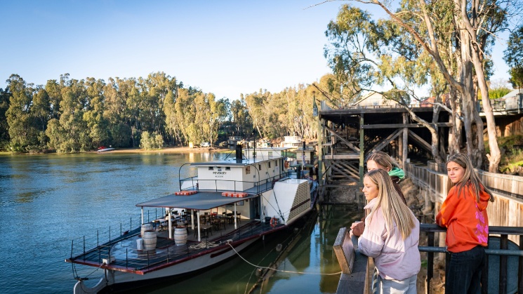 Students watching the river, houseboat in the foreground