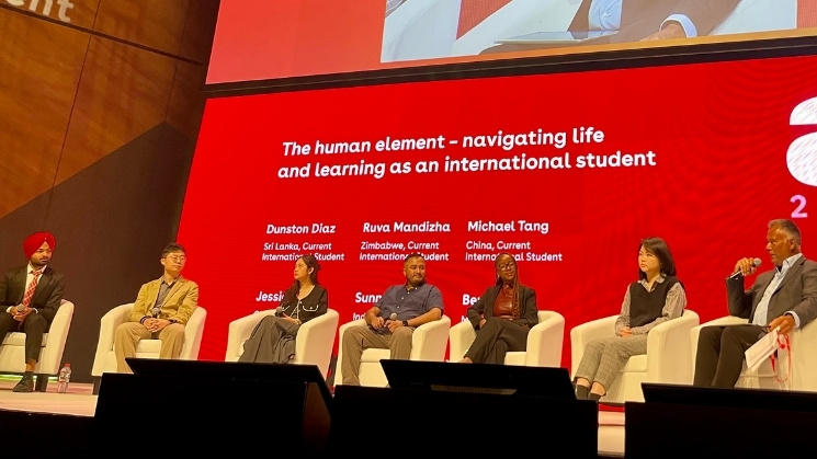 International student panel at recent AIEC conference, tagline on screen: The human element - navigating life and learning as an international student