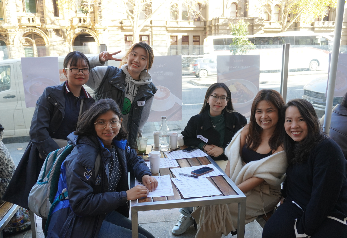 A group of students with coffee cups on a table 