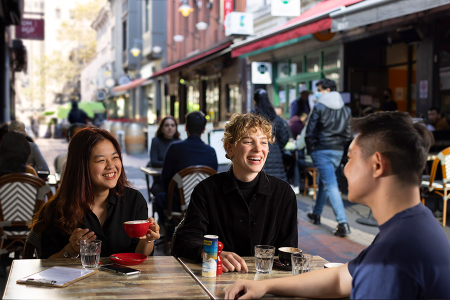 Three students sitting in cafe