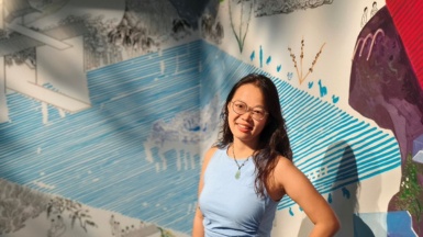 International student in front of artwork at Shanghai hub