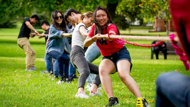 Students at boot camp workshop doing tug of war