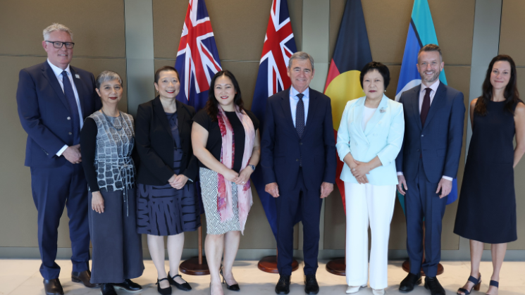 Advisory Council members 2025 in front of flags