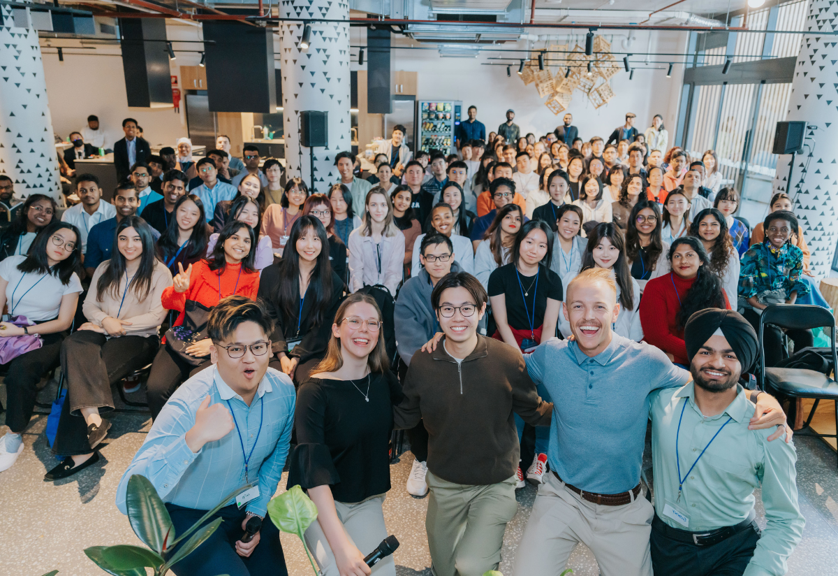A large group of people smiling and posing for a group photo at an event