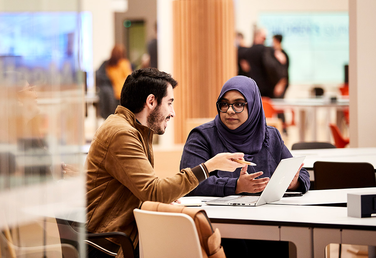 Young man and woman work in library