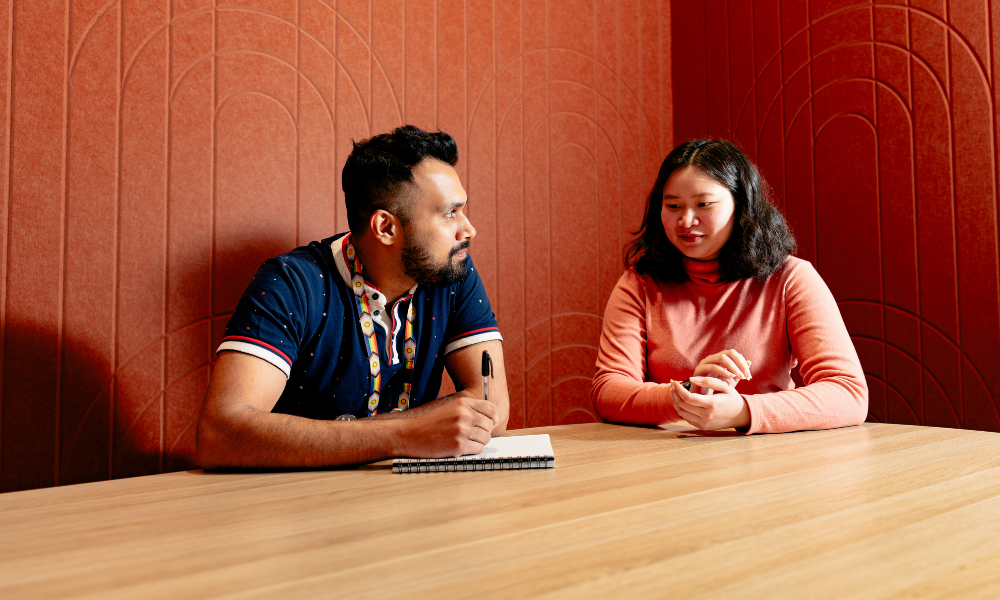 Three students sitting around a table
