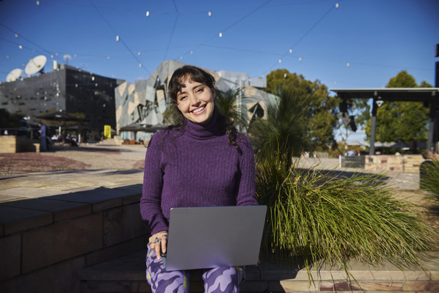 Woman working on laptop in cafe