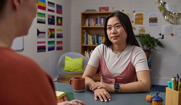 Student sitting by desk