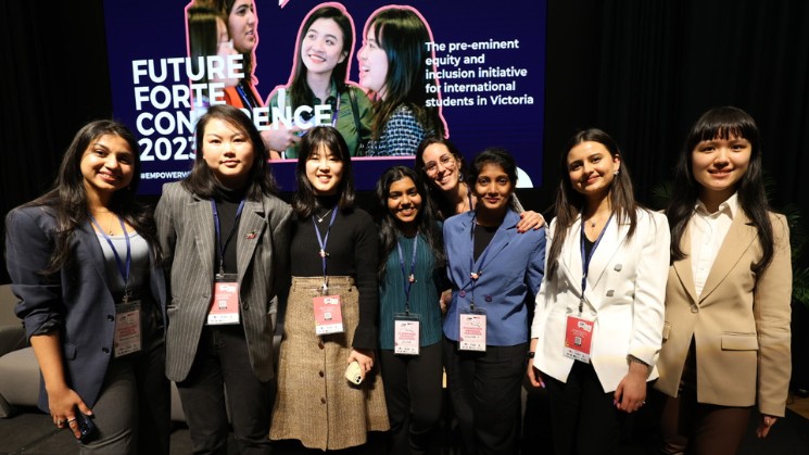 International students with Future Forte Conference 2023 #EmpoweredWomen sign, The pre-eminent equity and inclusion initiative for international students in Victoria