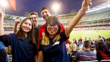 Students enjoying an AFL football game at the Melbourne Cricket Ground