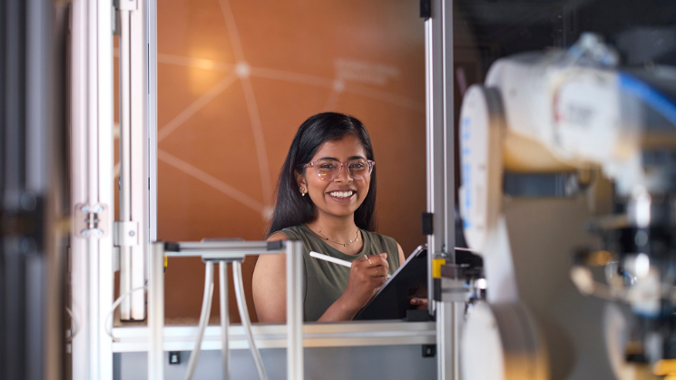 Student posing with a tablet and smart pen
