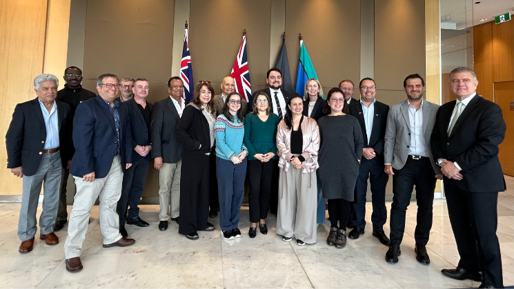 A delegation of representatives posing for a camera.