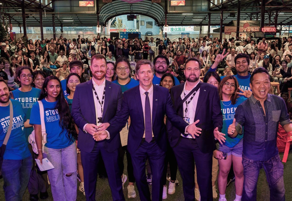 A large group of people smiling and posing for a group photo at an event