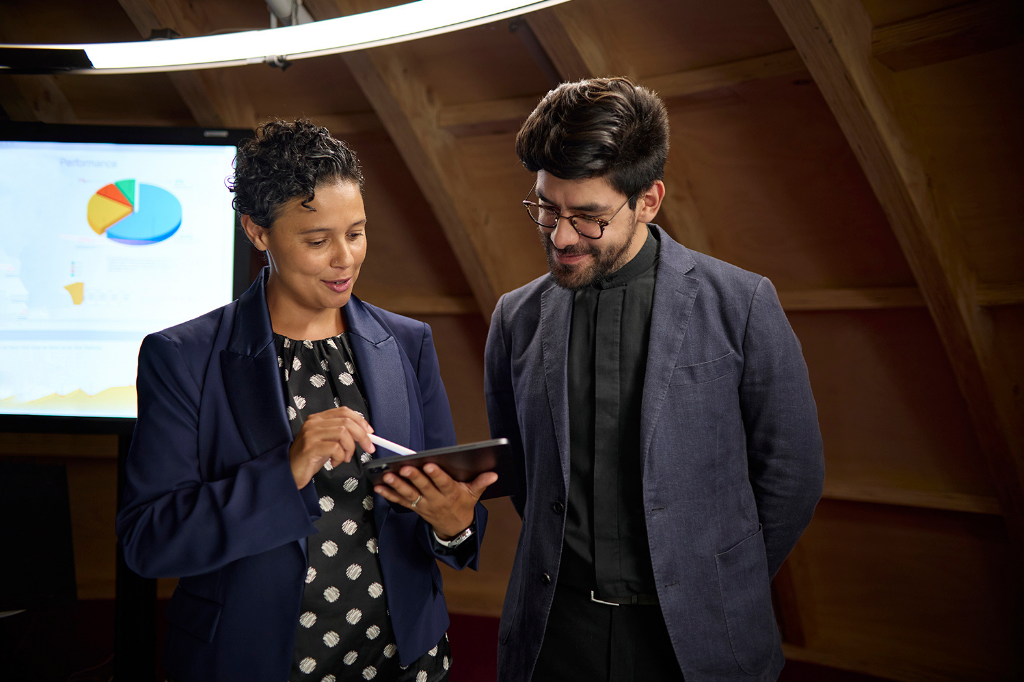 2 people looking at a tablet device