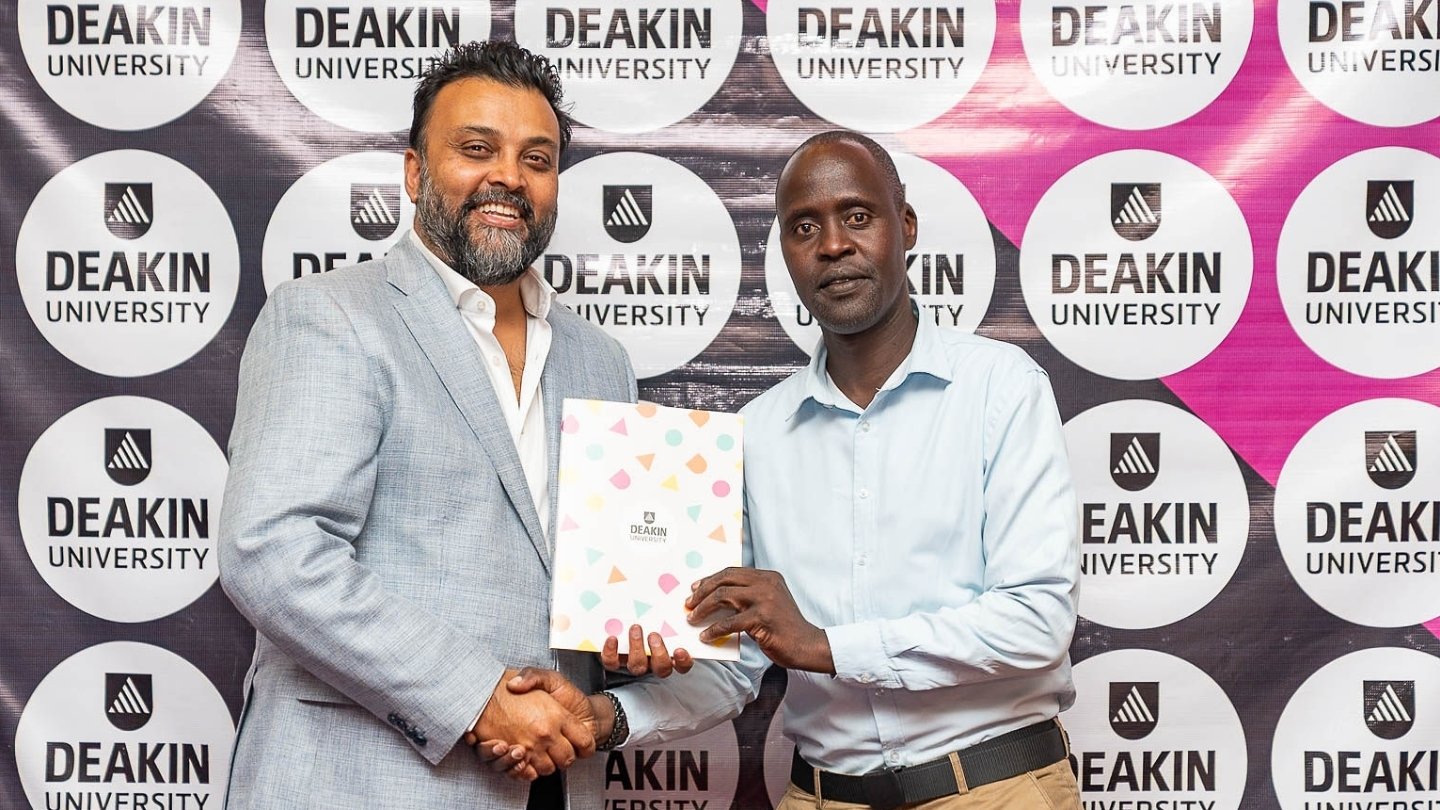 Award being presented with Deakin University logos in background