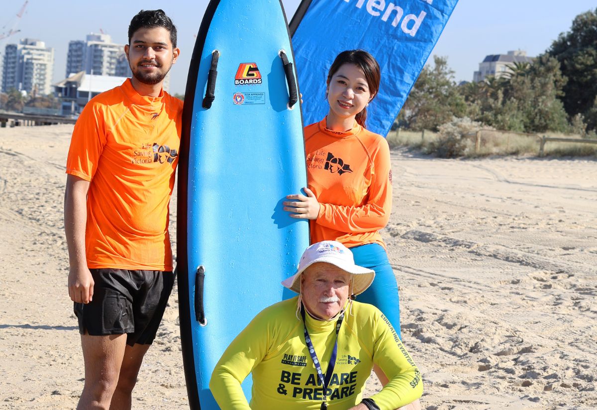 Two students and a lifeguard at the beach.