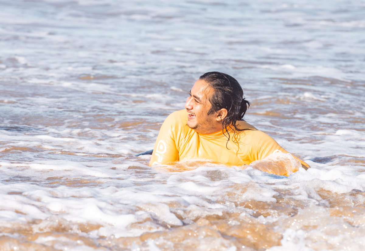 A person swimming on a board in the water