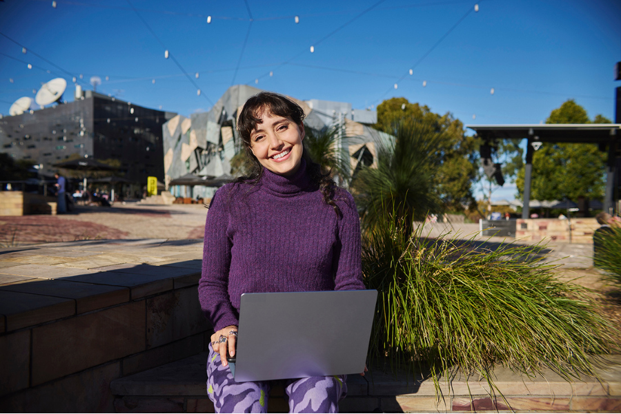 A student sitting with her laptop 