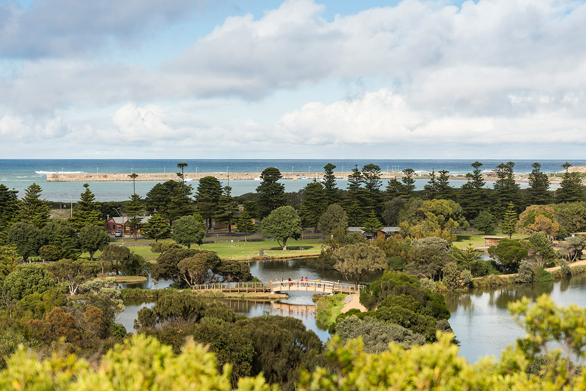 View through trees and wetlands to calm ocean