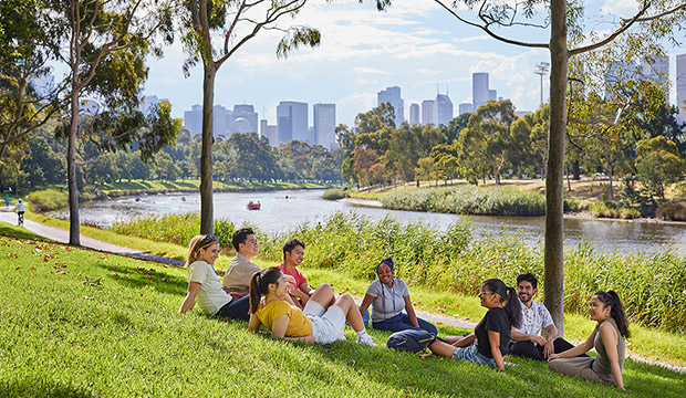 Group of friends sitting by the river