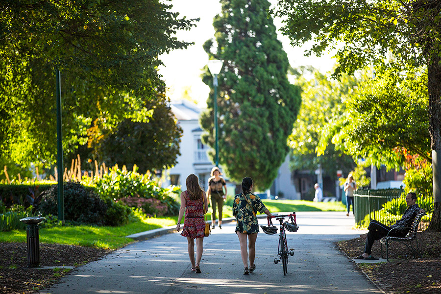 Pushing a bike through Carlton Gardens