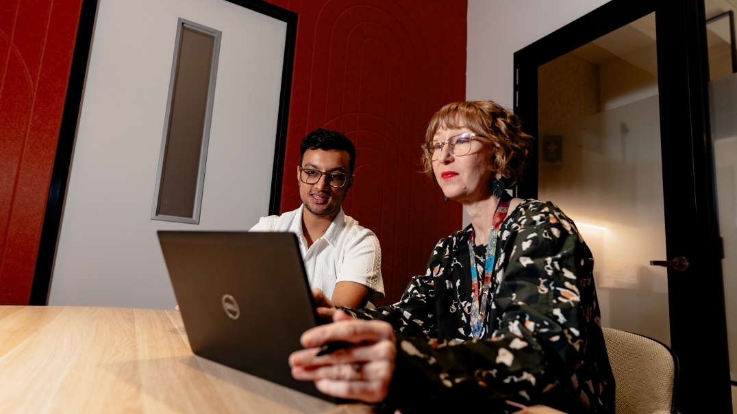 International student working with mentor in break out room at the Study Melbourne Hub