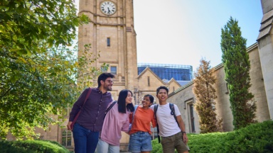 International students in front of the clock tower at The University of Melbourne