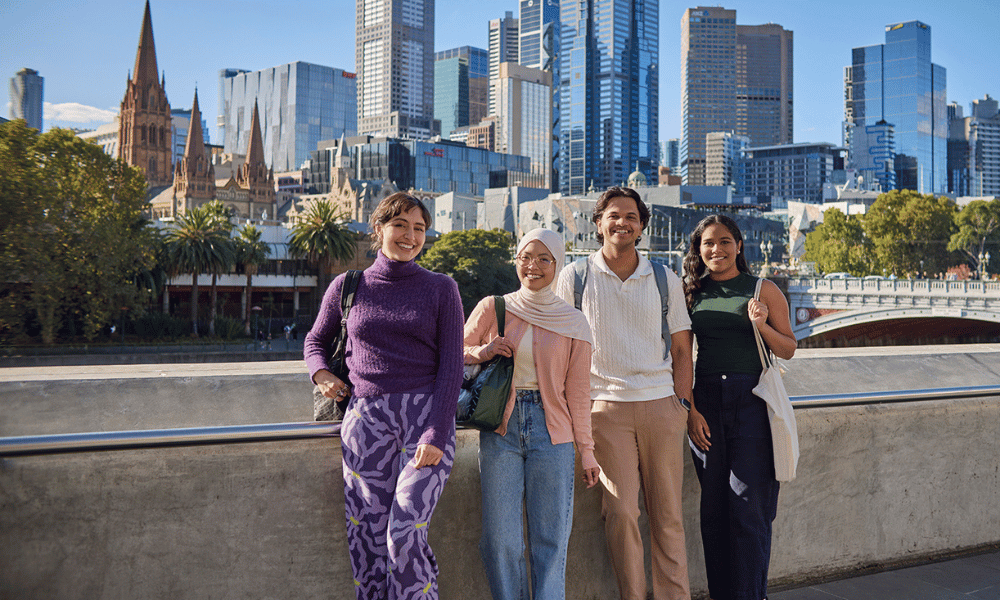 A group of people standing on a bridge 