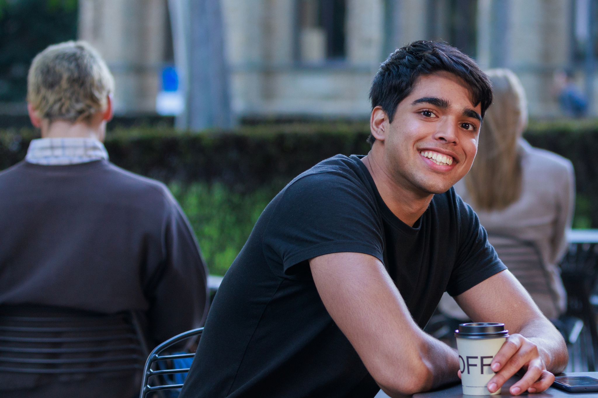 a student seated with a coffee