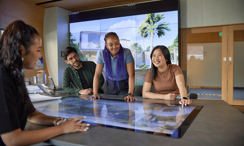 A group of people looking at a digital screen