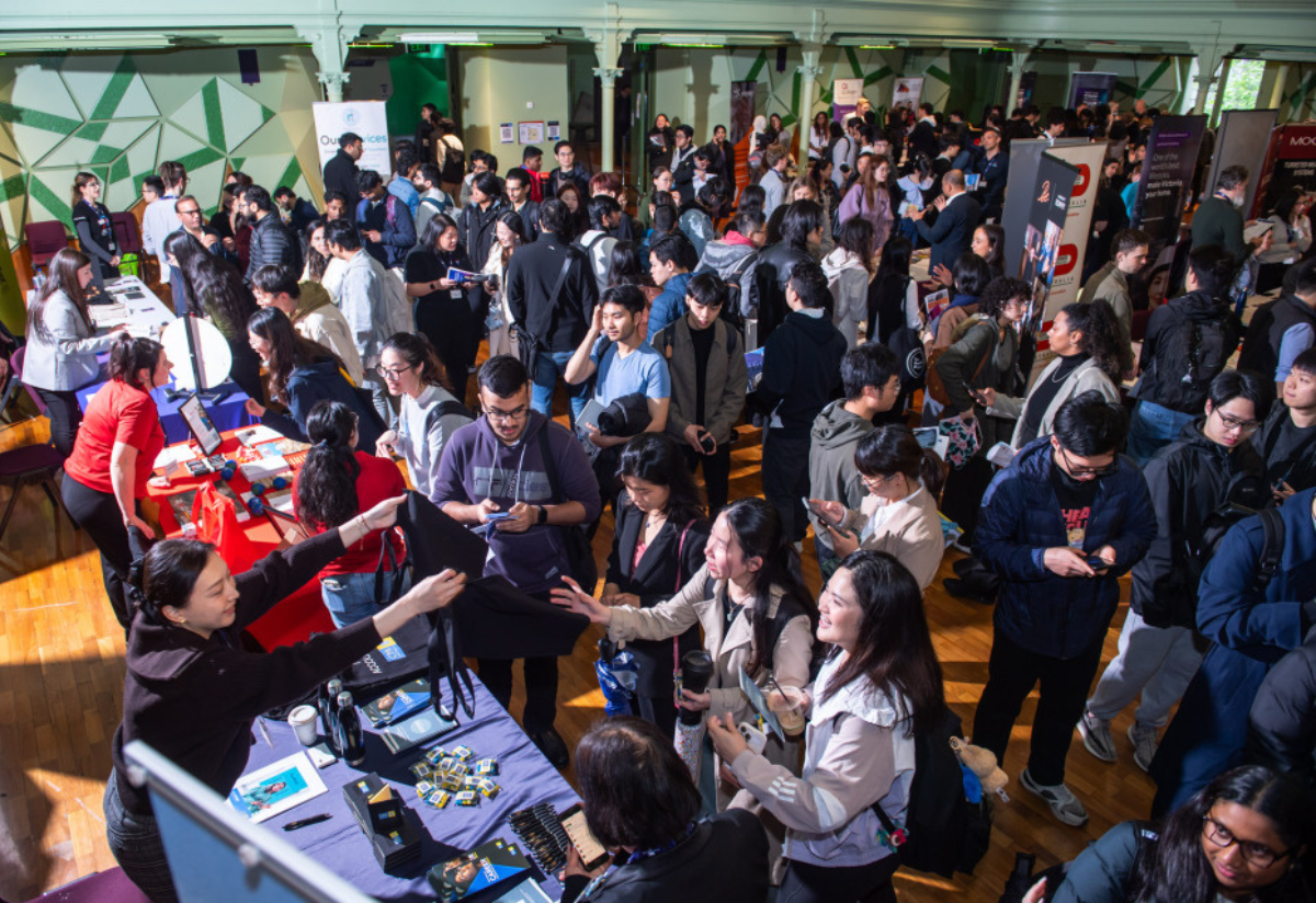 A photograph showing a busy gathering with diverse attendees
