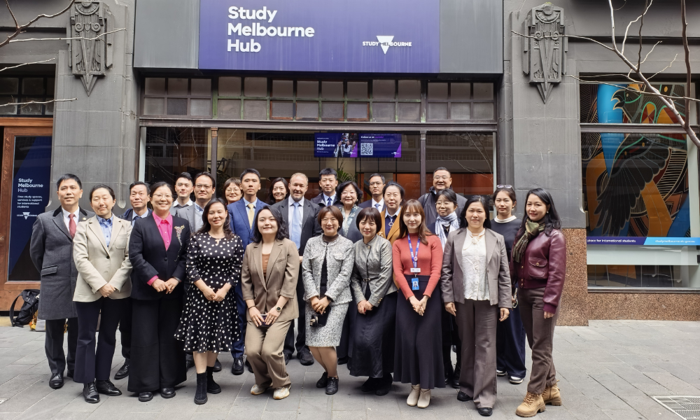 A group photo in front of the Study Melbourne Hub 