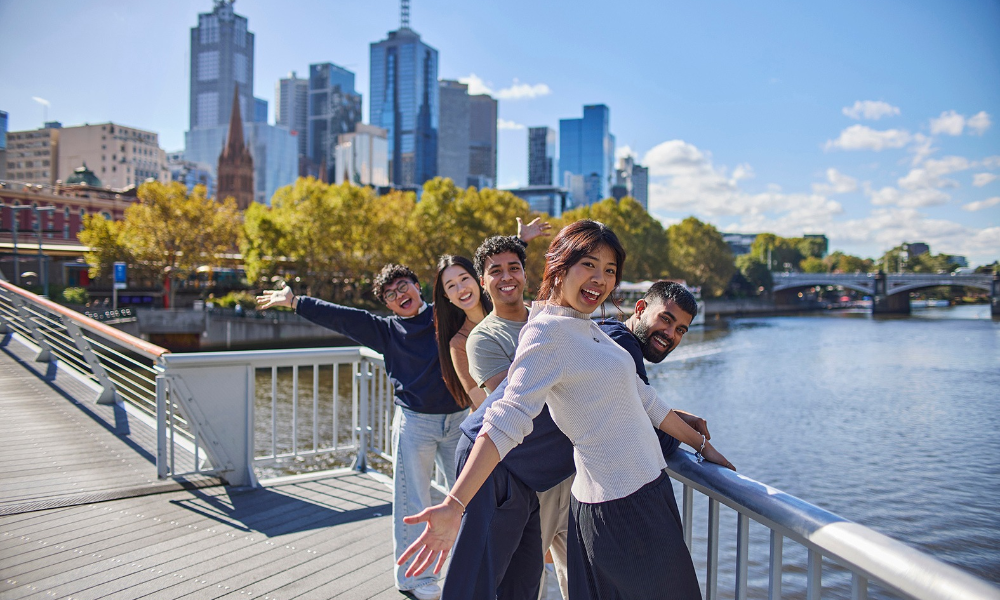 4 people together on a bridge