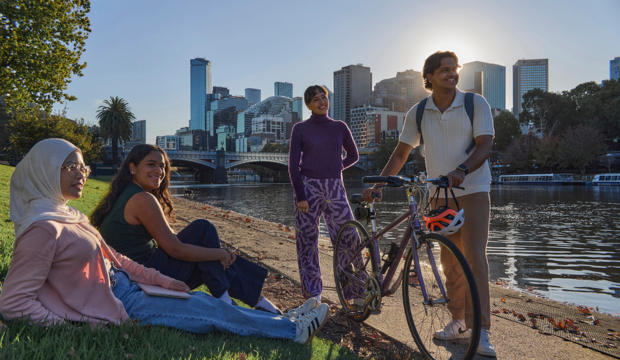 Students sitting by river