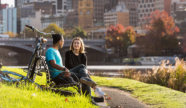 Students sitting by river