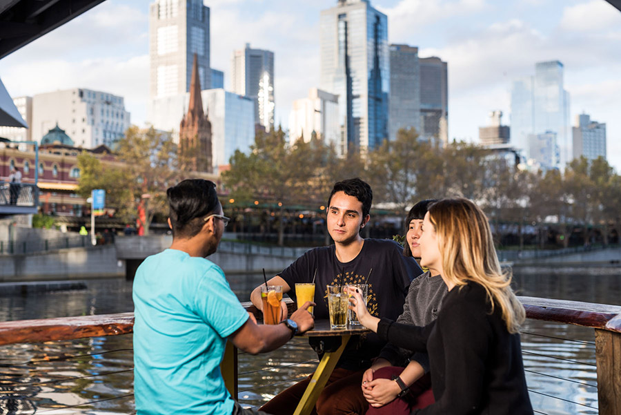 Students drinking in a bar by the river