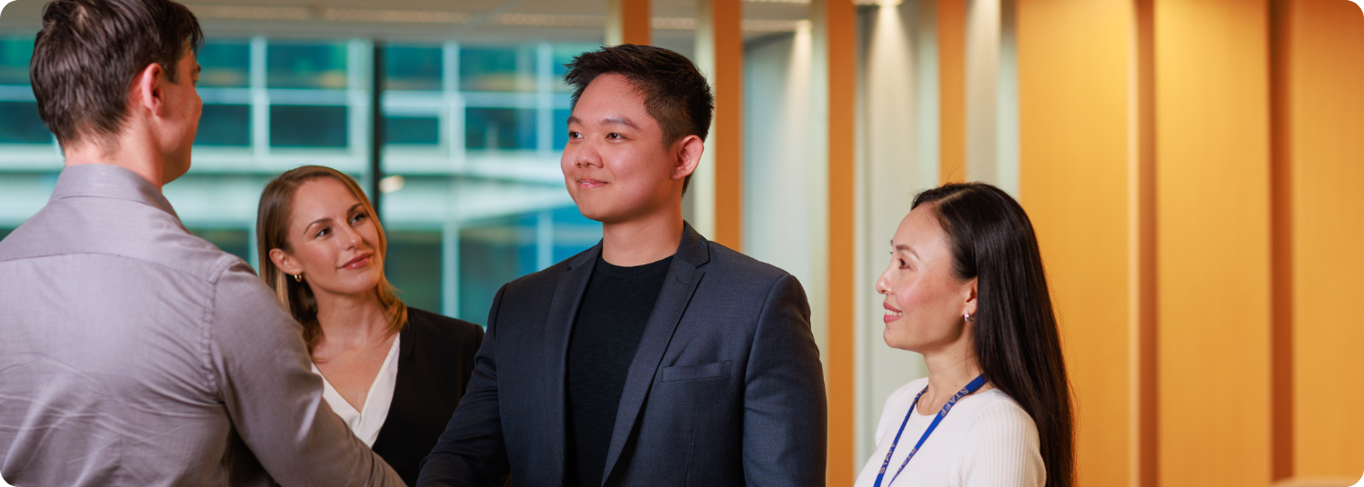 A student shaking hands with another person