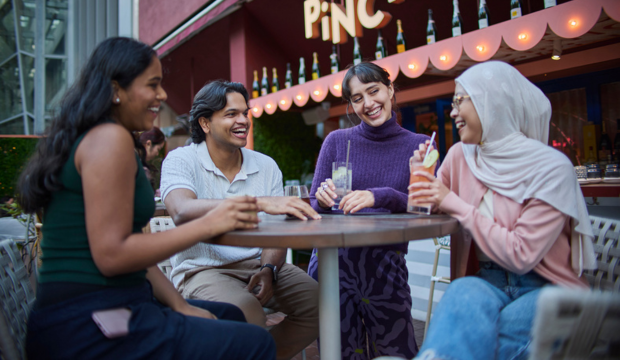 A group of people sitting together and having drinks
