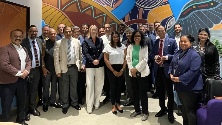 Group photo of delegation at Study Melbourne Hub with aboriginal artwork in the backgound