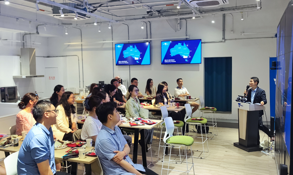 a group of people seated and watching a speaker 