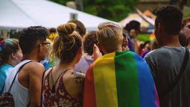 Students at a festival with rainbow flag