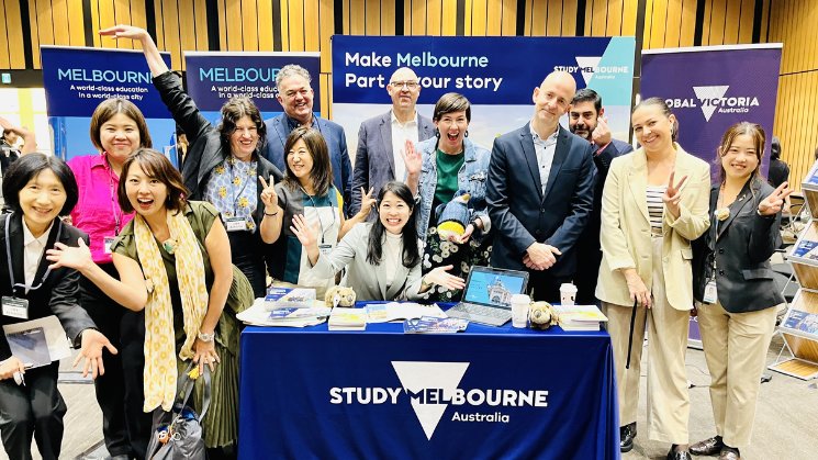 The Study Melbourne team enjoying the Japan Study Australia Education Fair. Banners in background Make Melbourne Part of your story, Study Melbourne Australia. Global Victoria logo.