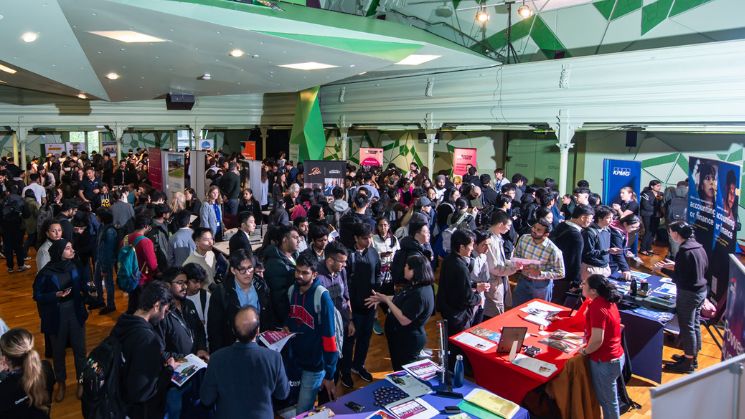 Hundreds of students mingling at the careers fair, stalls and banners on display